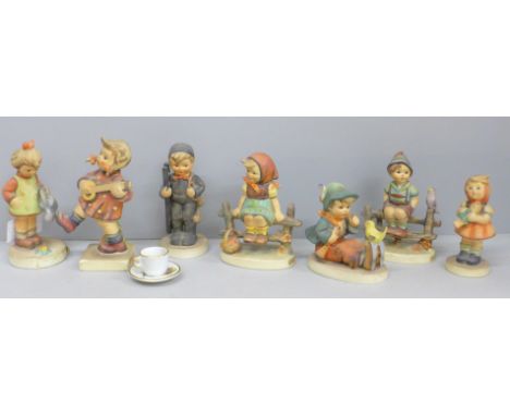 Seven Goebel figures and a miniature cup and saucer 