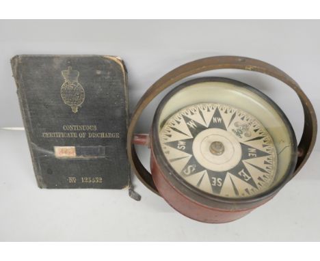 A dry card ship's compass and a Continuous Certificate of Discharge booklet, for John Stuart, service 1901-1924