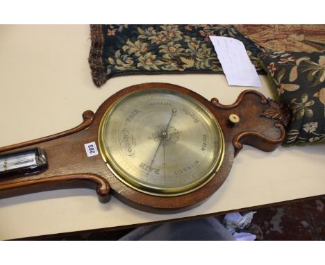 A Victorian oak mercury wheel barometer, mid 19th century, the 10 inch rosette-centred circular silvered register calibrated 