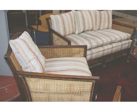 A William & Mary style walnut bergère suite, comprising sofa and pair of armchairs, on 'braganza' feet, striped upholstery, t