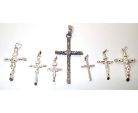Seven silver crucifixes largest H: 52mm 16.3g total. P&amp;P group 1 (£16 for the first item and £1.50 for subsequent items) 