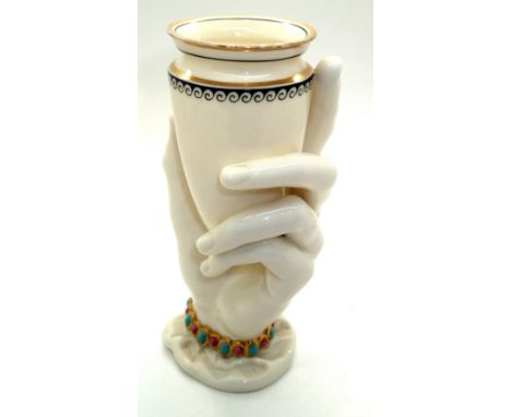 Royal Worcester glazed ceramic vase in the form of a hand grasping a conical receptacle, with painted and gilt decoration, H: