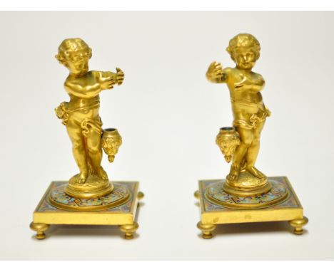 A pair of Victorian gilt ormolu and champlevé enamel spill holders, in the form of cherubs, 14.5 cm high
 Condition report Re