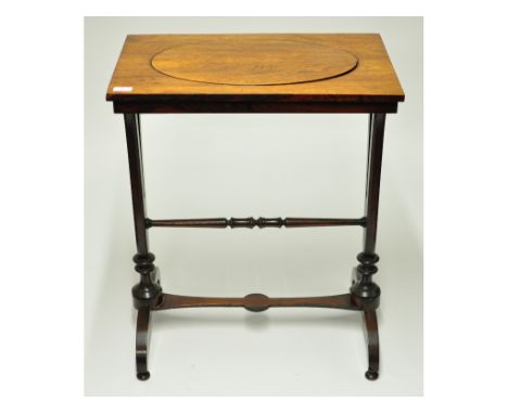 An early Victorian rosewood crocus planter table, with an oval well, on shaped end supports, joined by a turned pole structur