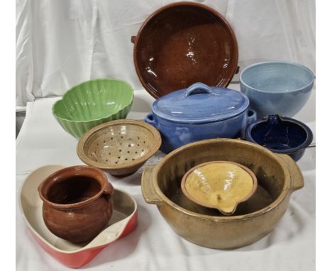 A collection of vintage kitchenware, including ceramic mixing bowls, serving dishes and casseroles. 