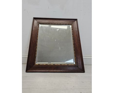 A vintage oak framed mirror with bevelled plate. H.66 W.56cm. 