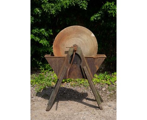 An antique grinding wheel the sandstone wheel in a cast iron trough and on wooden legs, 89cm wide x 120cm highCondition repor