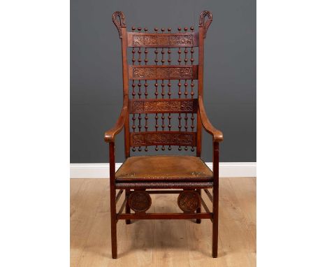An early 20th century possibly German high backed chair with bobbin turned decoration and inset with embossed leather panels,