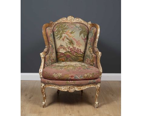 A 19th century continental beechwood framed wing back armchair with tapestry upholstery and cabriole legs, 74cm wide x 70cm d