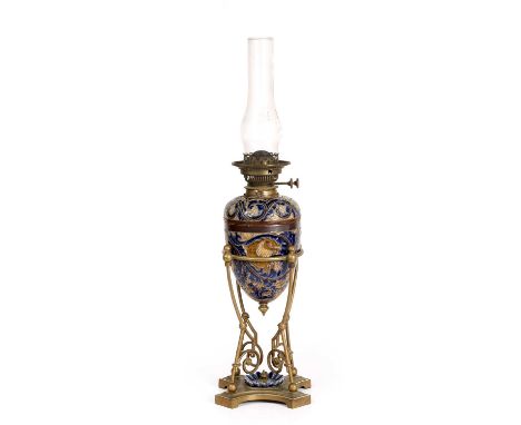 A Victorian Doulton stoneware and brass oil lamp the reservoir and body decorated by Mark V Marshall with foliate decoration 
