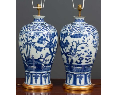 A pair of contemporary chinese style blue and white porcelain table lamps of inverted baluster form with turned gilt socles a