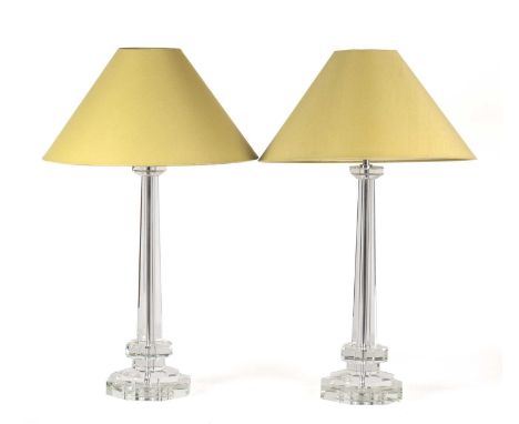 A pair of faceted cut glass table lamps of octagonal form with stepped bases and light green shades, 50cm in height excluding