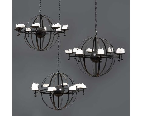 A set of three black painted wrought iron globular eight light chandeliers, each approximately 78cm wide x 53cm high and with
