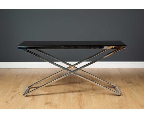 A contemporary chrome plated X framed console table with black glass top, 134cm wide x 40cm deep x 68.5cm highCondition repor