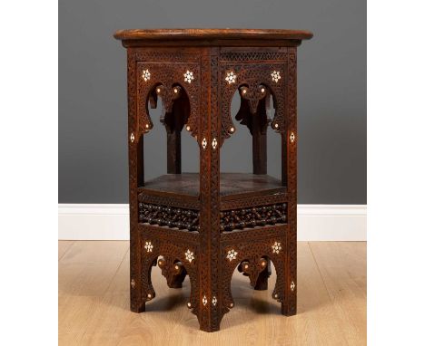 An early 20th century Moorish hardwood hexagonal occasional table with carved Islamic script and mother of pearl inlay, the c