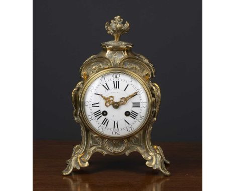 A 19th century French rococo style cast brass mantle timepiece, the enamel roman dial indistinctly signed, the Parisian movem