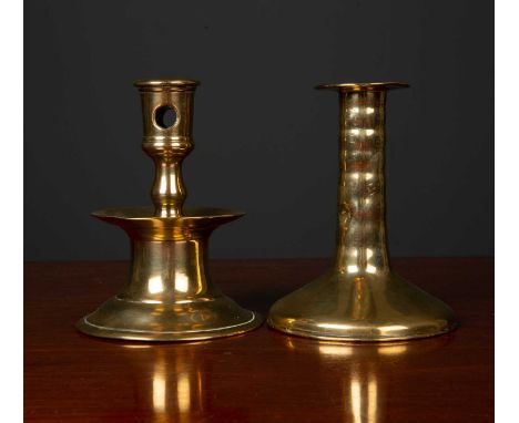 A mid to late 17th century brass candlestick with turned stem and spreading base, 9.5cm diameter x 12cm high together with a 