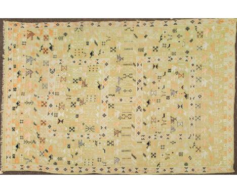 A light green kelim rug, the field decorated with stylised animals and birds, within two rectangular boxes, and within a geom