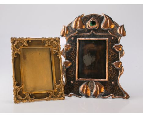 An Art Nouveau beaten copper photograph frame decorated with stylised leaves and green enamel plaque, together with a French 