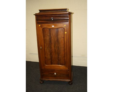 A 19th century French mahogany cupboard, the caddy top over a cushion moulded drawer and a serpentine panel cupboard door enc