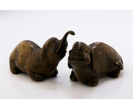 A pair of Chinese scroll weights, fashioned as young elephants, 12cm