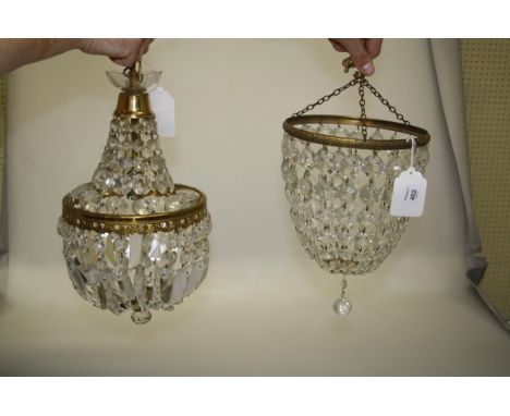 An Edwardian style gilt metal and cut glass bag chandelier with prismatic drop finial, 21cm, together with a similar larger b