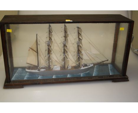 A circa 1920s scratch built model of a four masted clipper in full sail, in a period oak glazed case, 41 x 83 x 25cm