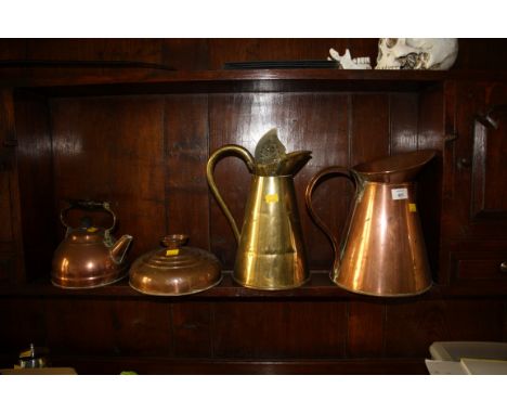 A Victorian copper conical loop handled jug, a brass jug, copper kettle, a Georgian steel handled copper ladle, a copper foot