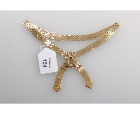 A 9ct gold necklace, the cross-over brick link chain with arrow head terminals