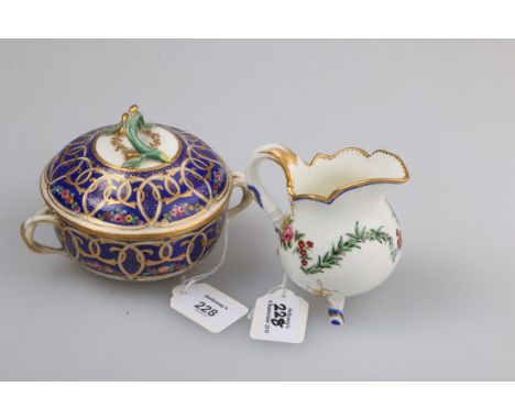 A late 18th century Sevres porcelain twin handled cup and cover, with fruiting branch finial over broad bleu de roi bands wit