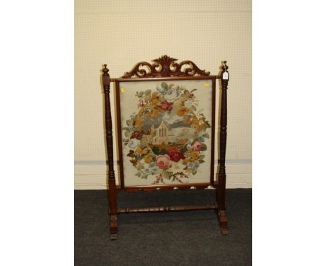 A late Victorian mahogany firescreen having a scrolling acanthus surmount above a glazed gros point and beadwork panel of an 