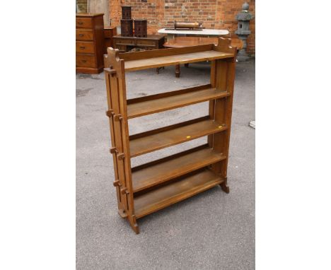 An Edwardian oak adjustable five shelf bookcase, with shaped ends, 92cm wide