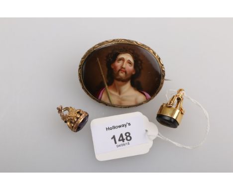 A Victorian intaglio seal of a gentleman in gold mount, together with a gilt metal Victorian seal and a porcelain brooch depi