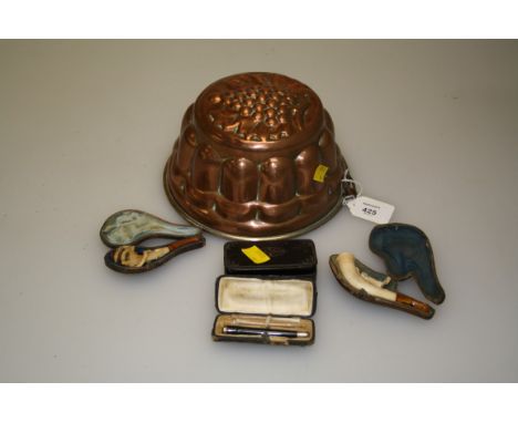 A meerschaum pipe with simulated amber mouthpiece carved with a recumbent horse, another carved with eagle talon and serpent,