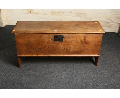 An 18th century elm six plank coffer, the wire hinged top with moulded edge over front with iron lock, dated 1739, enclosing 