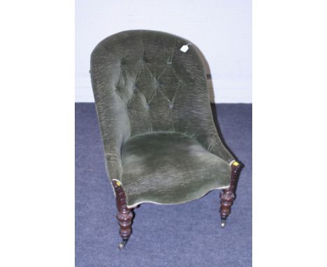 A Victorian button backed nursing chair with turned rosewood supports