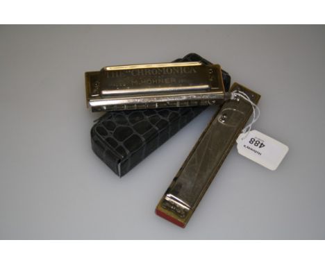 A Hohner Chromonica 260 in simulated crocodile case, together with one other harmonica