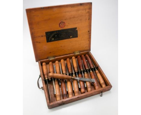 An Edwardian set of eighteen Ward and Payne, SJ Addis carving tools, each with stamped steel blade and ring turned handle, in