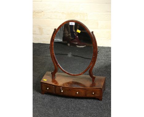 A 19th century mahogany satinwood strung toilet mirror, the oval plate within swept horns on a three drawer bow front base, w