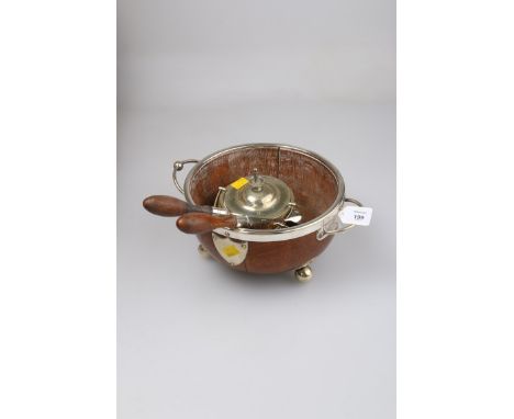 A late Victorian oak salad bowl with twin EP handles and mounts on three ball feet, together with a pair of servers and a but