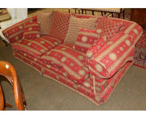 A Duresta Feather-Filled Three-Seater Sofa, modern, upholstered in red and gold Aztec pattern fabric, with six scatter cushio