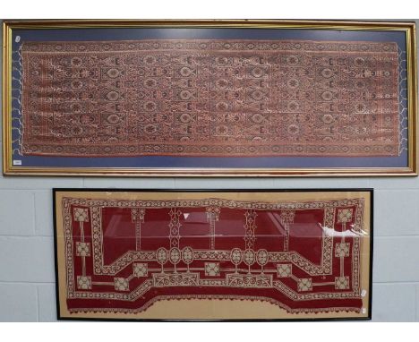 An Art Noveau Needlework Panel, with cream borders on a deep red ground, shaped and with one tassel edge, framed, 137cm by 54