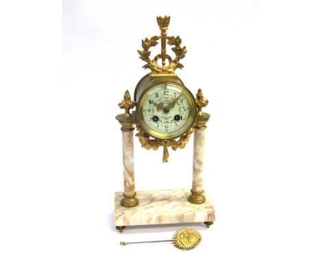 A late 19th Century French gilt-brass and onyx portico clock with hand painted/enamelled Arabic dial with pierced gilt brass 