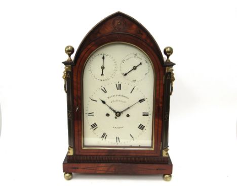 An early 19th Century mahogany and brass inlaid bracket clock of architectural form, arched painted metal dial (some paint lo