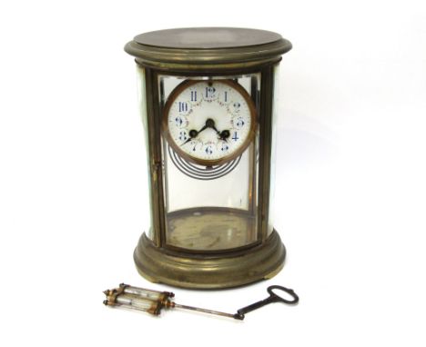 A 19th Century French brass cased four glass mantel clock of oval form, Arabic enamelled dial. 8 day movement with rack and s