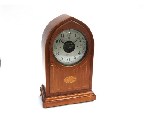 An Edwardian mahogany and satin line inlaid "Bulle" electric mantel clock of lancet form, Arabic silvered dial, etched by ret