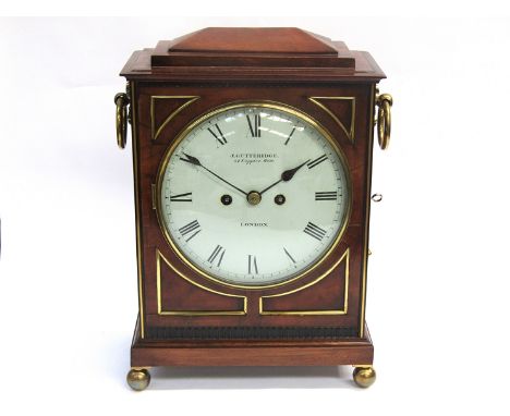 An early 19th Century mahogany bracket clock with brass ball feet, bezel, pierced side fret panels and side handles, painted 