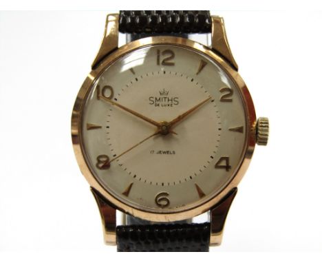 SMITHS: a DeLuxe 9ct gold cased gent's manual wind wristwatch, two-tone silvered dial with Arabic even numerals, dagger marke