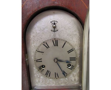 An Edwardian mahogany mantel clock of lancet form, silvered arched dial with Roman chapter ring. 8 day striking and chiming m