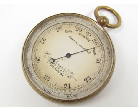 An early 20th Century gilt brass cased pocket aneroid barometer by Frodsham